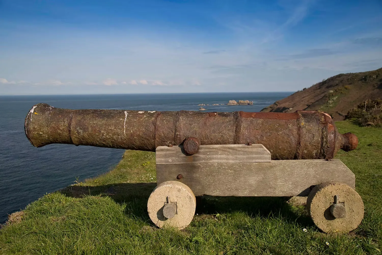 An old cannon on a wooden carriage overlooking the sea from a Sark clifftop, Channel Islands