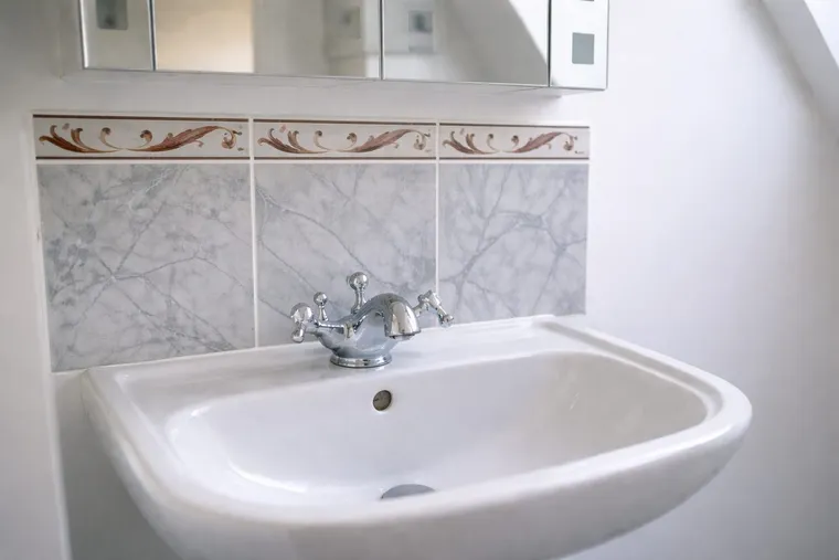 The bathroom sink in the Coastal Rose room at the retreat house on Sark