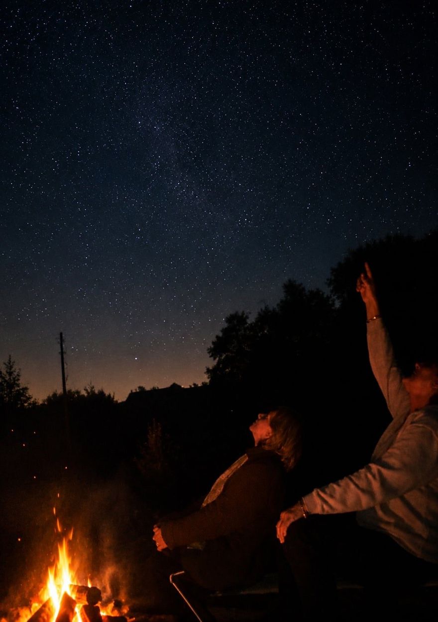 Stargazing by firelight under the night sky on Sark, Channel Islands