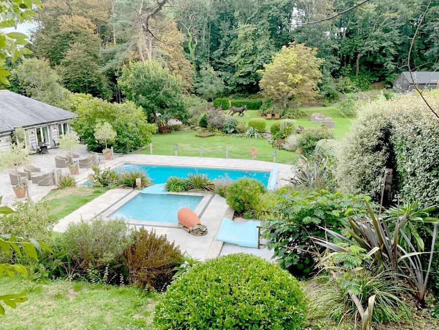 The heated outdoor pool in the gardens of the retreat house on Sark