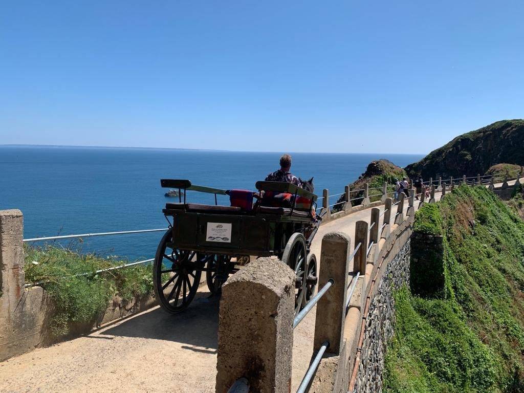 Guests riding a horse and carriage on car-free Sark, Channel Islands