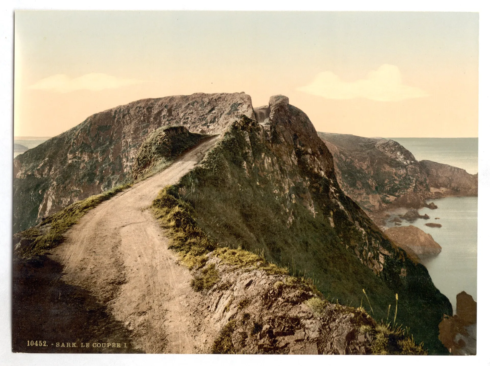 An 1890s photochrom of the narrow La Coupee track before modern railings, Sark, Channel Islands