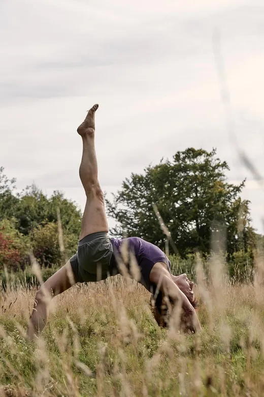 A yoga pose in a wildflower meadow on Sark