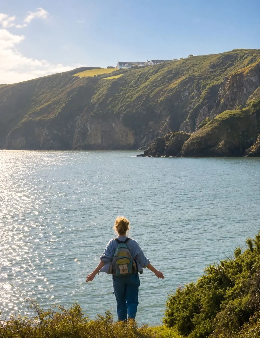 Nadia, founder and host, looking out over the sea from the cliffs of Sark, Channel Islands