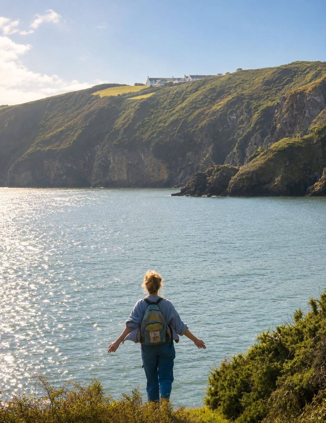 Nadia, founder and host, looking out over the sea from the cliffs of Sark, Channel Islands