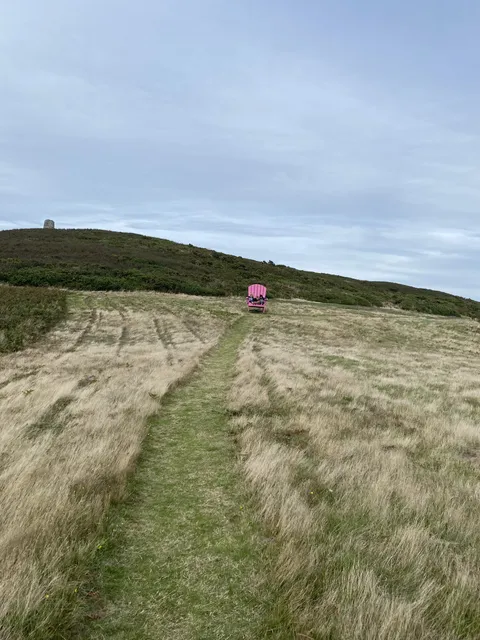 A chair on a hilltop path above the sea on Sark, Channel Islands