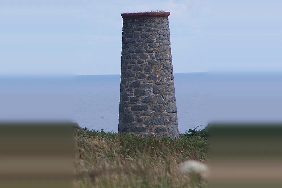The derelict ventilation chimney of Sark's old silver mine at Port Gorey, Little Sark, Channel Islands