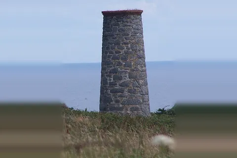 The derelict ventilation chimney of Sark's old silver mine at Port Gorey, Little Sark, Channel Islands
