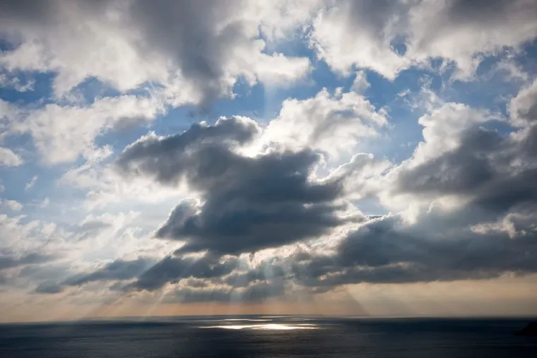 Sunbeams breaking through clouds over the sea off Sark
