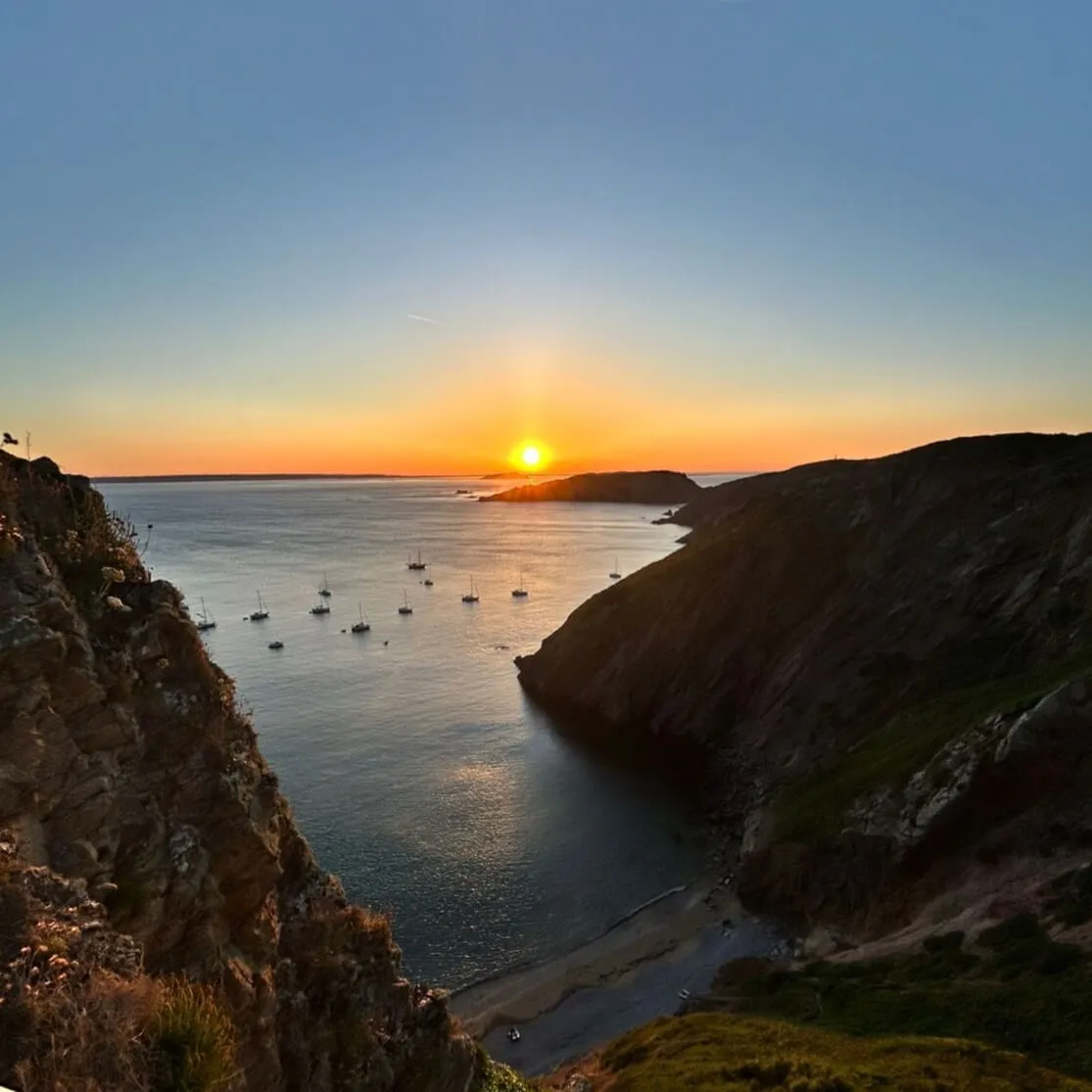 Yachts anchored in a bay at sunset on Sark, Channel Islands