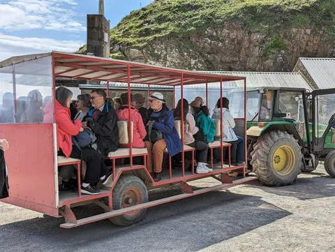 Guests travelling from Maseline Harbour on Sark's tractor-drawn toast rack