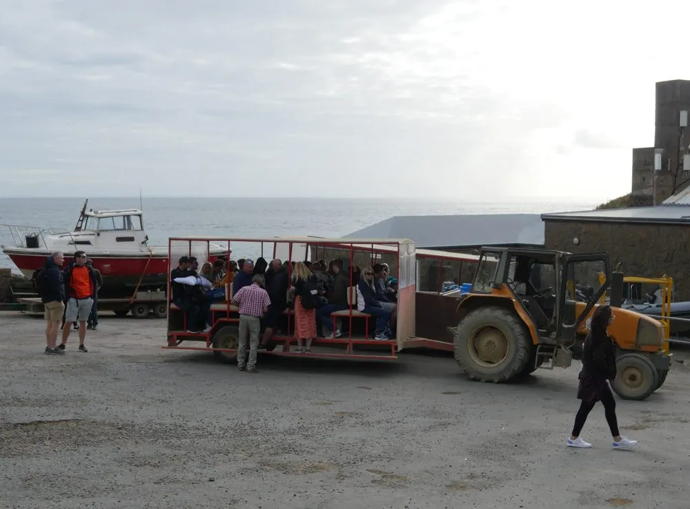 Arriving on car-free Sark by tractor-drawn toast rack from the harbour at dusk
