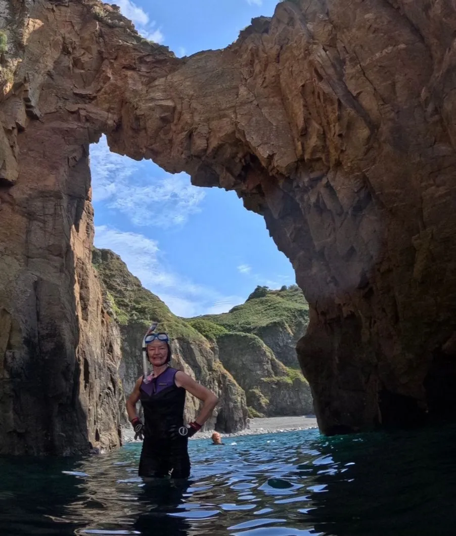 Wild swimming beneath the rock arch on Sark, Channel Islands